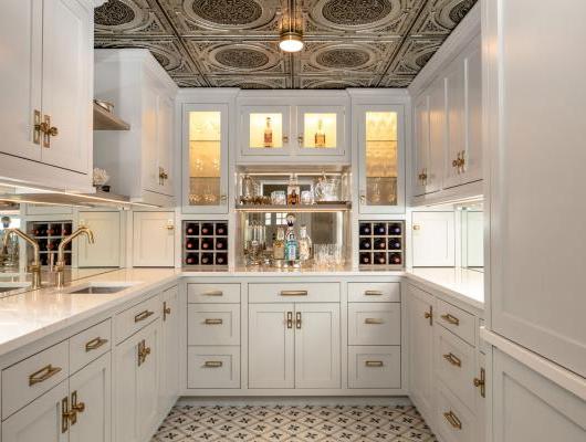 Butler's pantry converted from a bank vault with tin ceilings and white cabinets