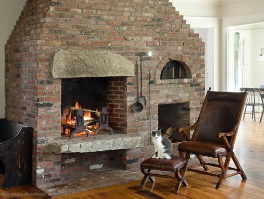 Cozy fireplace in a great room by D. Michael Collins Architects